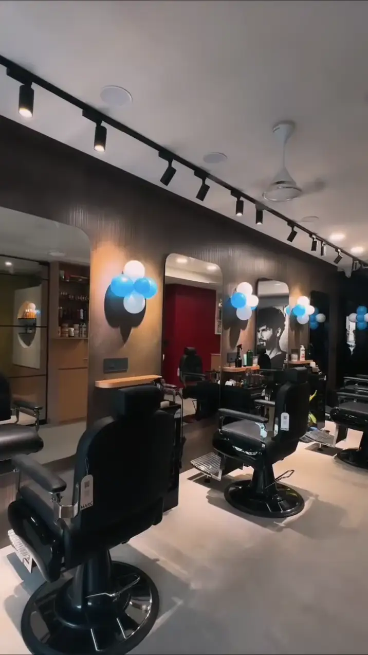 Row of black barber chairs under track lights