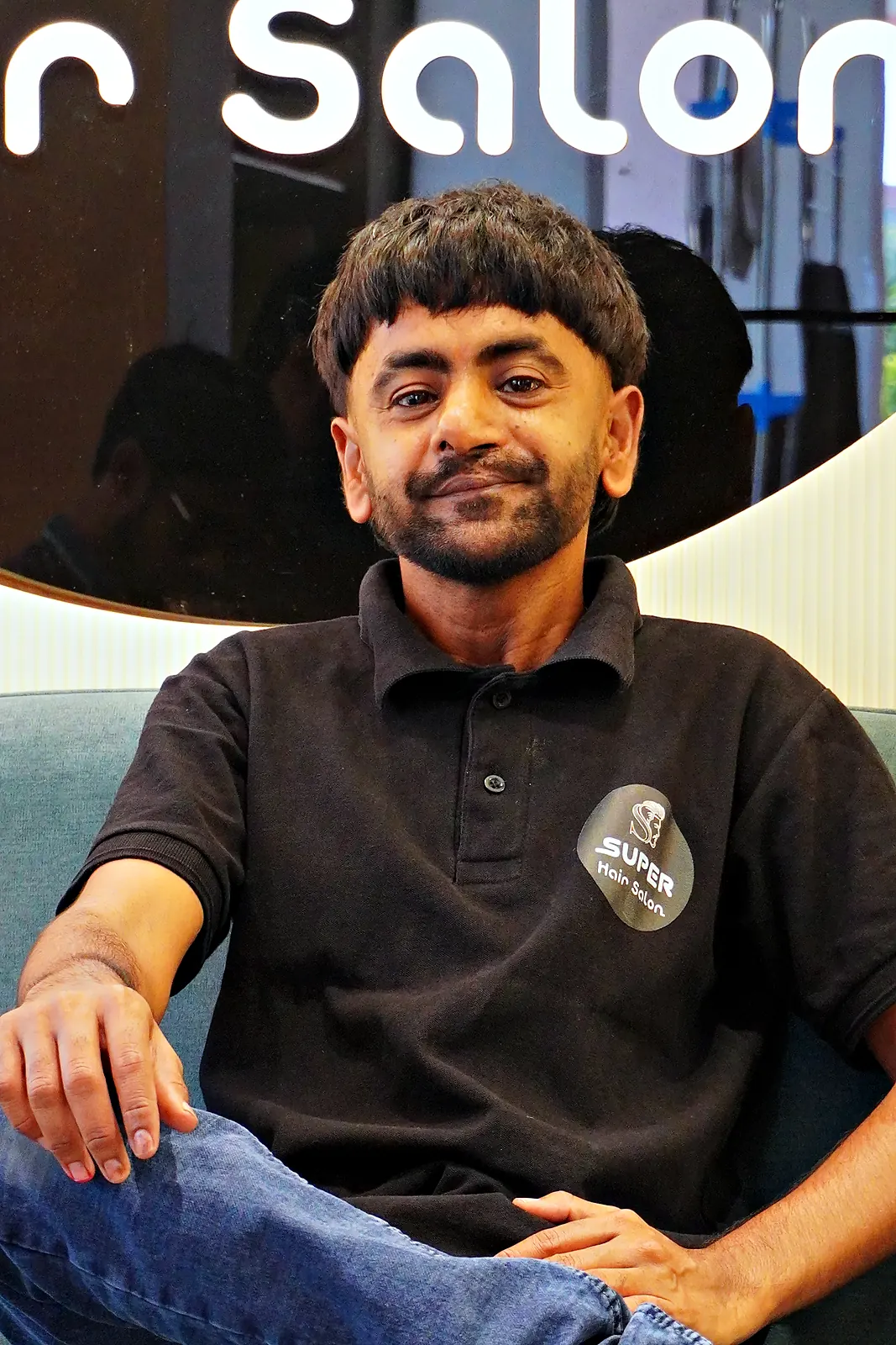 SUPER Hair Salon barber in the branded black tee
