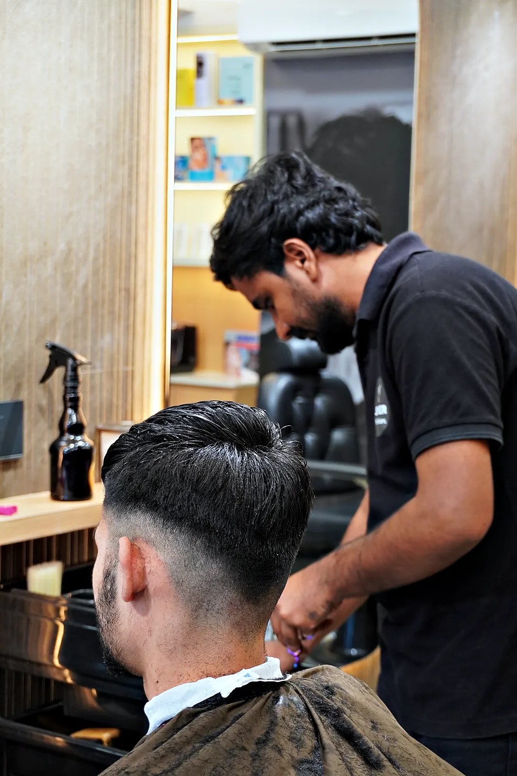 Back view of a fresh fade with a hard part