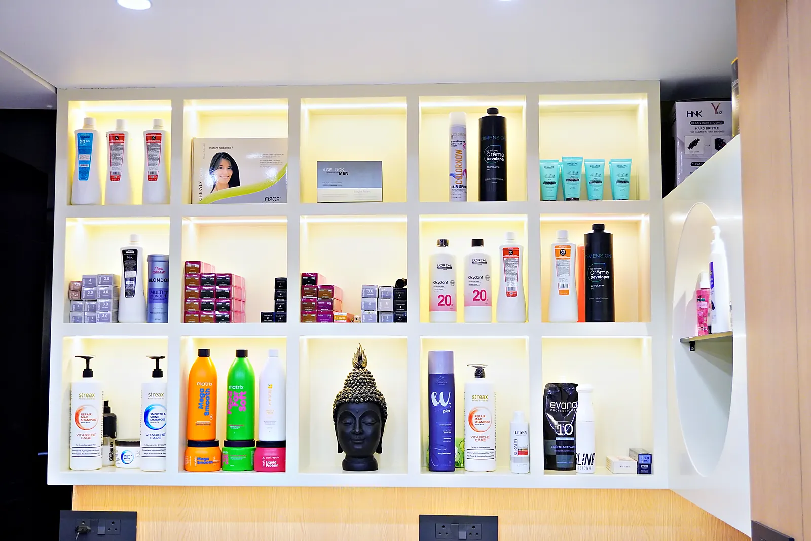 Backlit shelves of hair care and colour products