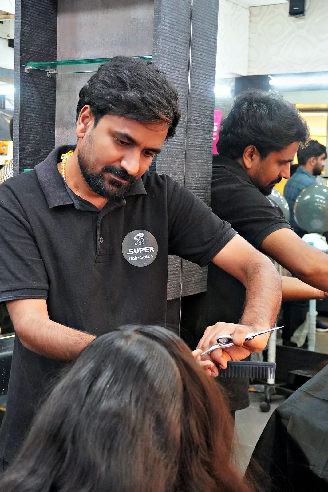 Stylist cutting a client's long hair