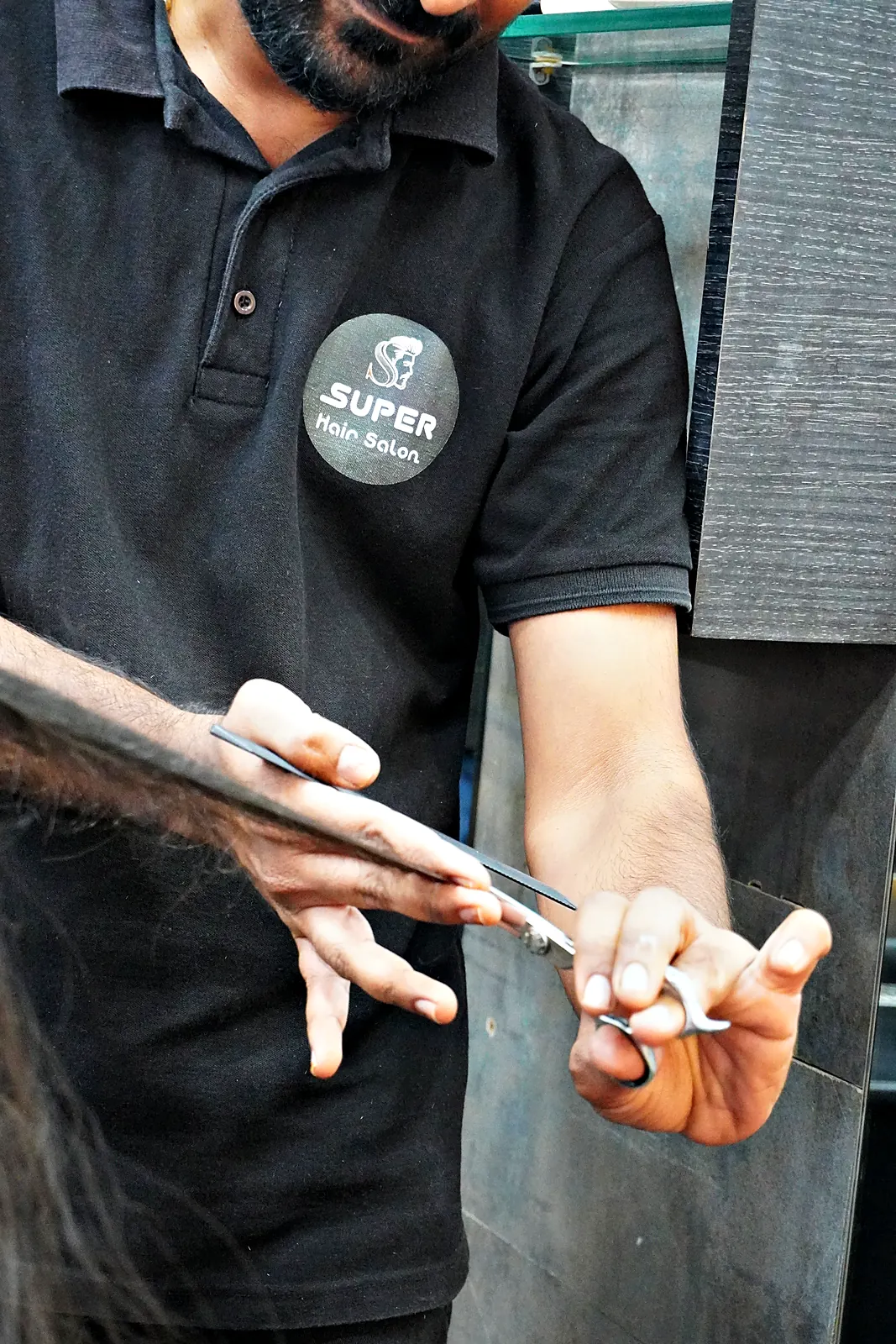 Close-up of scissors cutting long hair